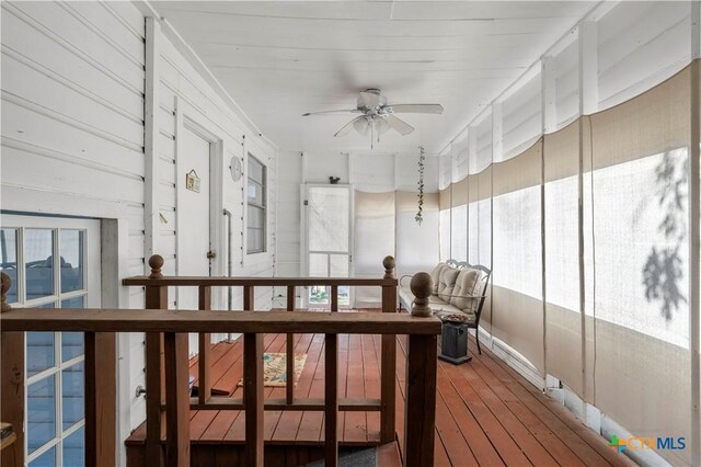 sunroom featuring ceiling fan