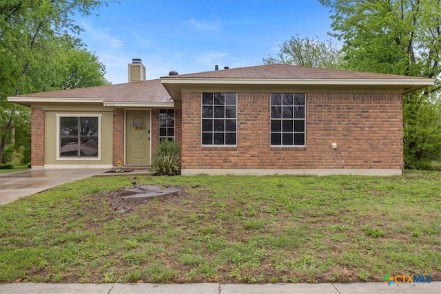 4103 Koala Dr, Killeen, TX 76543 - ranch-style home with brick siding, a front yard, roof with shingles, and a chimney