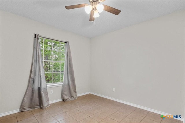 4103 Koala Dr, Killeen, TX 76543 - empty room with light tile patterned floors, baseboards, a ceiling fan, and a textured ceiling