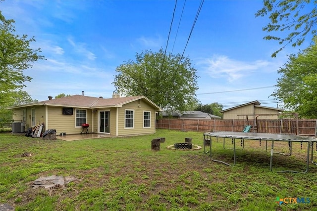 4103 Koala Dr, Killeen, TX 76543 - back of house with a patio area, a fenced backyard, a trampoline, and a yard