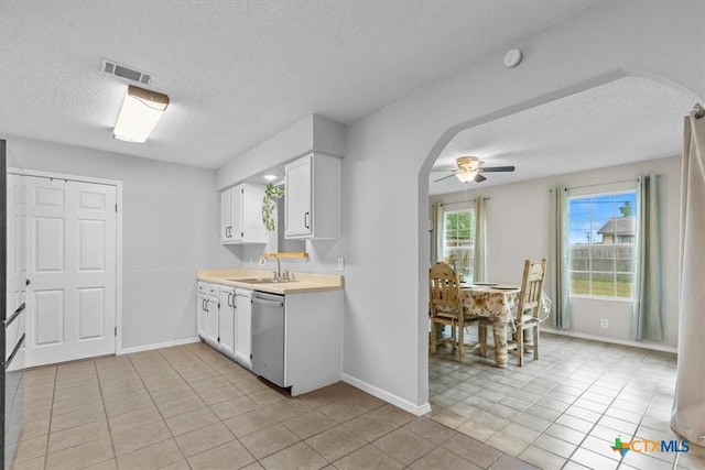 4103 Koala Dr, Killeen, TX 76543 - kitchen with arched walkways, dishwasher, visible vents, and a textured ceiling