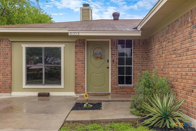 4103 Koala Dr, Killeen, TX 76543 - doorway to property featuring a chimney and brick siding