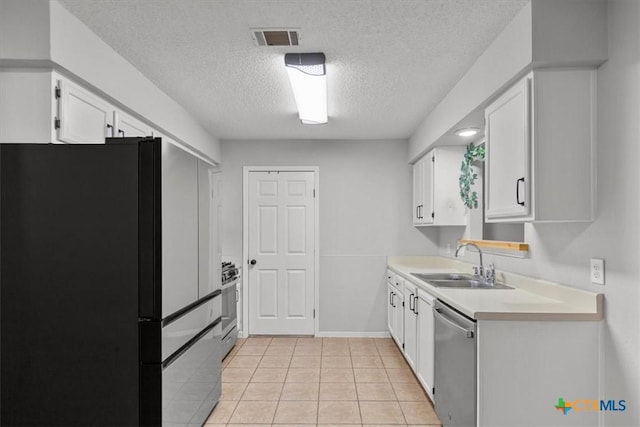 4103 Koala Dr, Killeen, TX 76543 - kitchen with a textured ceiling, white cabinets, visible vents, appliances with stainless steel finishes, and a sink