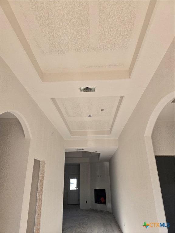 hall featuring a raised ceiling