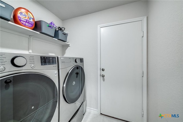 clothes washing area featuring laundry area and separate washer and dryer