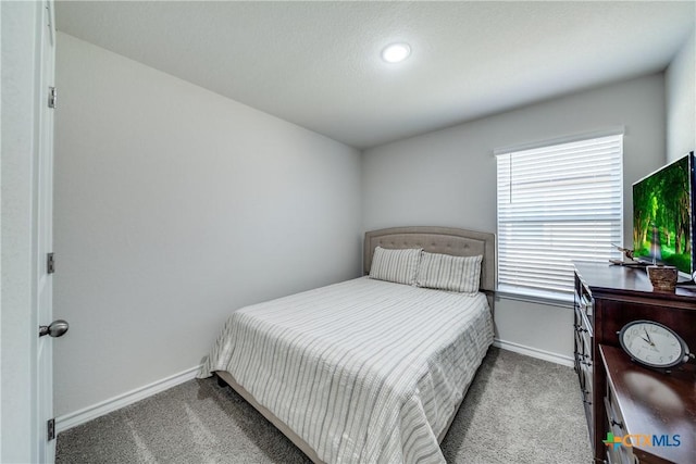 bedroom with carpet and baseboards