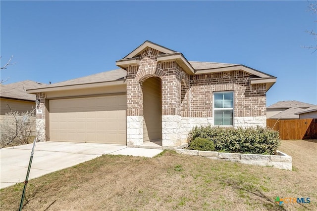 view of front facade featuring brick siding, concrete driveway, stone siding, an attached garage, and a front yard