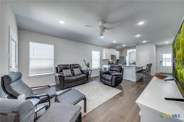 living room with a ceiling fan, baseboards, dark wood-type flooring, and recessed lighting