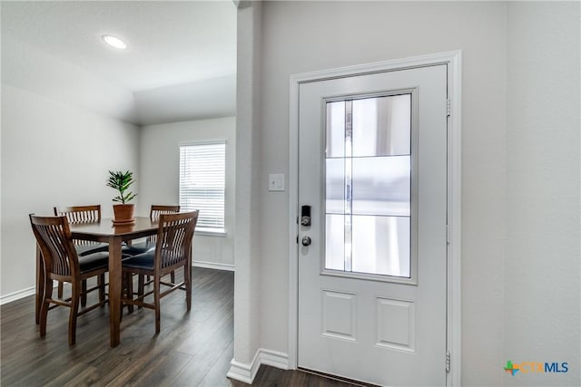 doorway to outside with vaulted ceiling, dark wood-style flooring, and baseboards