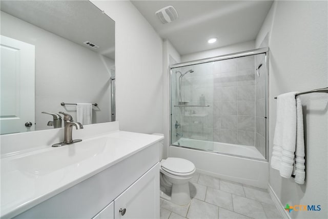 bathroom with toilet, vanity, tile patterned flooring, and visible vents