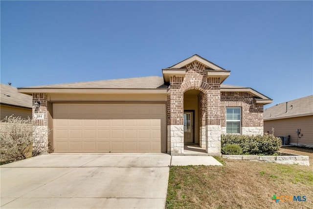 view of front of house with an attached garage, stone siding, concrete driveway, and brick siding