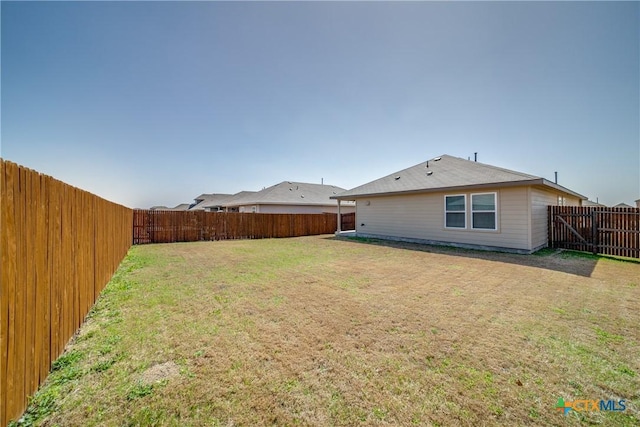 view of yard with a fenced backyard