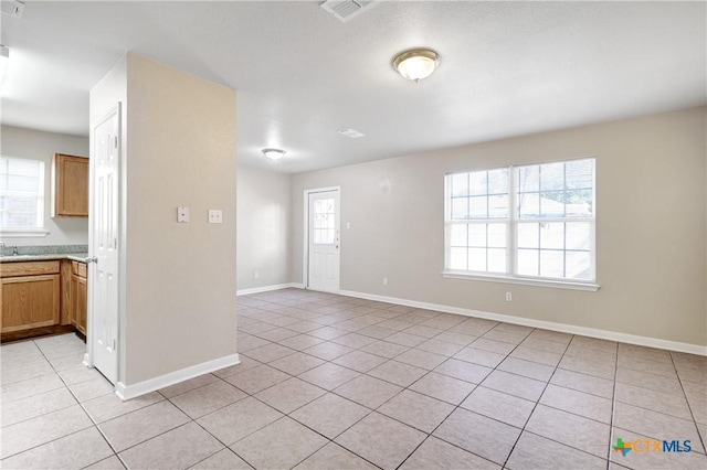 interior space featuring light tile patterned flooring and plenty of natural light