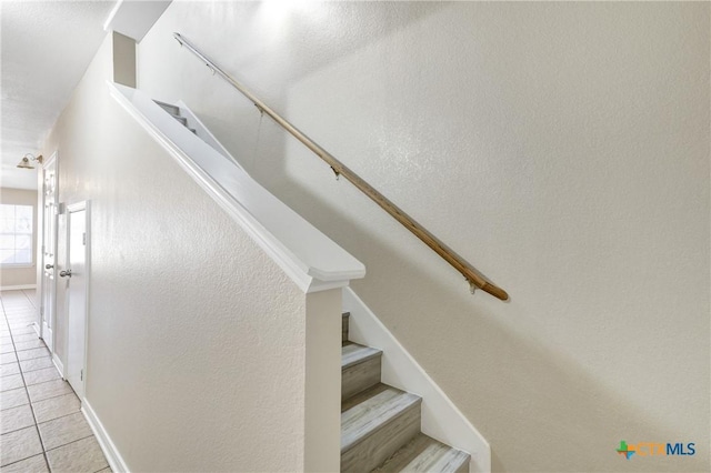 stairway featuring tile patterned flooring