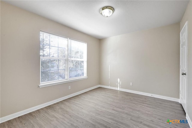 spare room with hardwood / wood-style floors