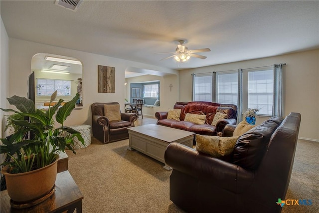 living room featuring light carpet and ceiling fan