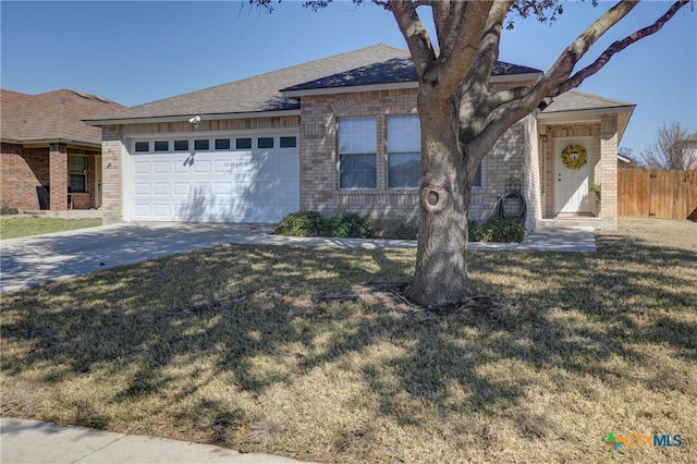 ranch-style home featuring a garage and a front yard