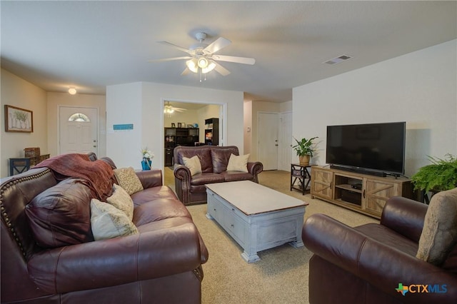 living room with ceiling fan and light carpet