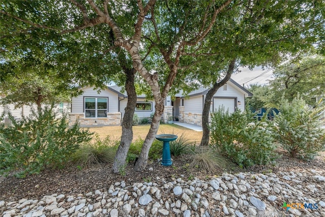 1175 Lavaca, Canyon Lake, TX 78133 - view of front of house with stone siding and an outbuilding