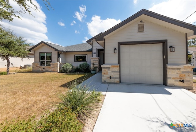 view of front of house with a garage and a front yard