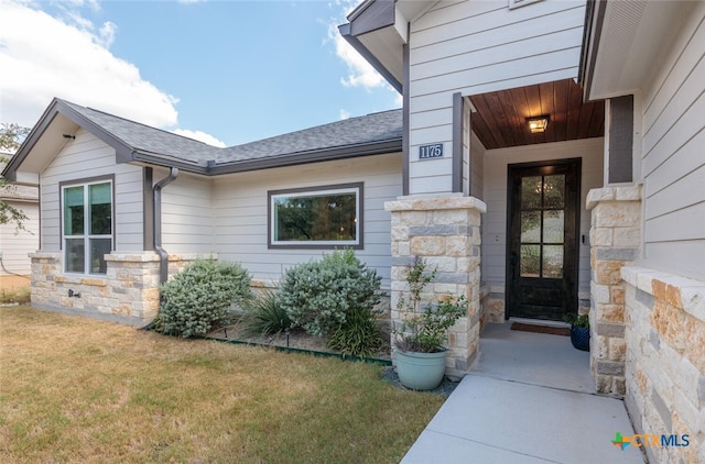 doorway to property featuring a yard