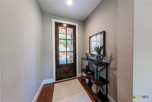 1175 Lavaca, Canyon Lake, TX 78133 - doorway with a textured wall, baseboards, and dark wood-style floors