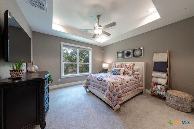 1175 Lavaca, Canyon Lake, TX 78133 - carpeted bedroom featuring a tray ceiling, ceiling fan, baseboards, and visible vents