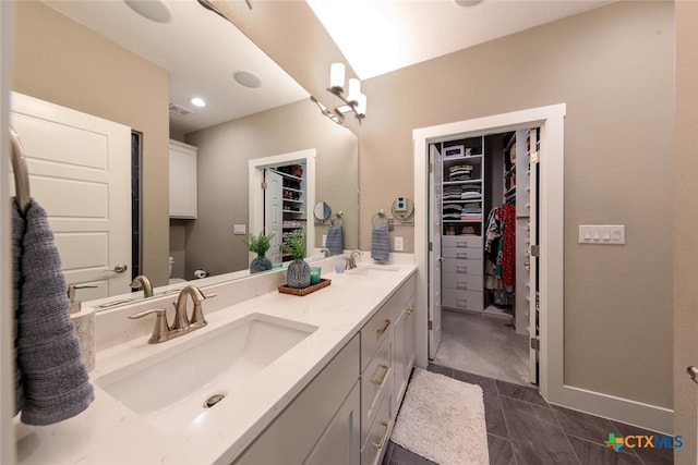 1175 Lavaca, Canyon Lake, TX 78133 - bathroom featuring toilet, double vanity, a sink, and a walk in closet