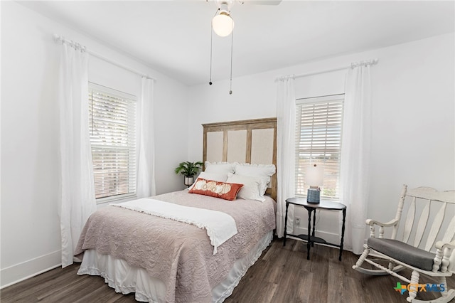 bedroom with multiple windows, ceiling fan, and dark hardwood / wood-style floors