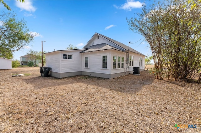 rear view of house with central AC