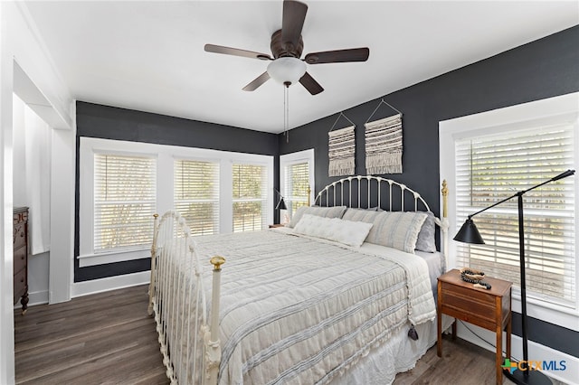 bedroom with dark wood-type flooring and ceiling fan