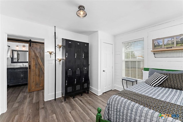 8410 Alaska Ave, Temple, TX 76502 - bedroom featuring wood finished floors and a barn door