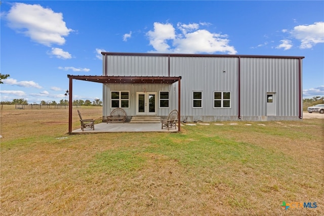 back of house featuring a pergola, a lawn, and a patio area