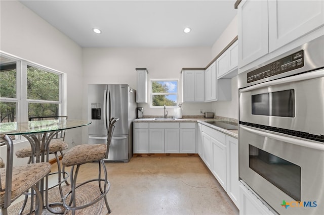 kitchen with white cabinets, stainless steel appliances, and sink