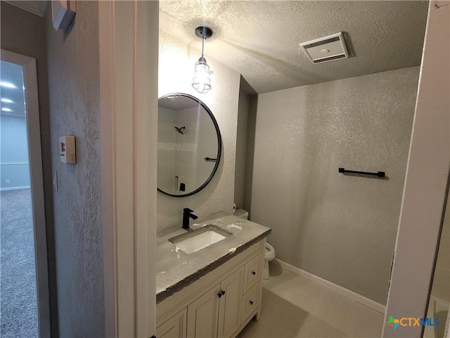 4106 Ermine Trl, Temple, TX 76504 - full bath with toilet, vanity, a textured ceiling, a shower, and a textured wall