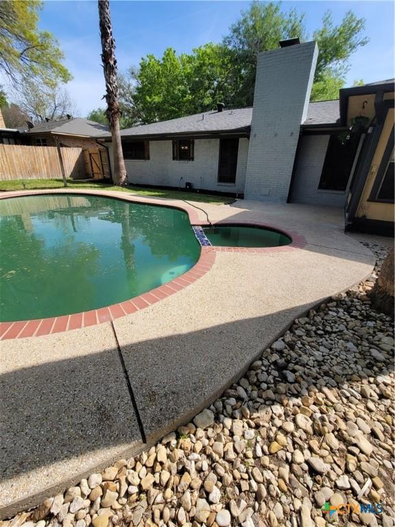 4106 Ermine Trl, Temple, TX 76504 - view of swimming pool with fence, a patio area, and a pool with connected hot tub