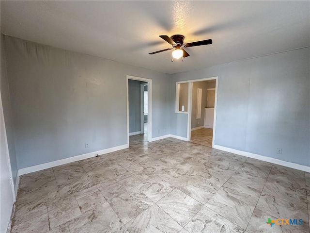 spare room with ceiling fan