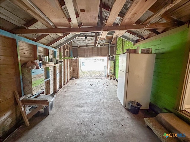 misc room with wooden walls, gas water heater, and vaulted ceiling