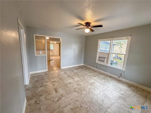 spare room featuring a textured ceiling and ceiling fan