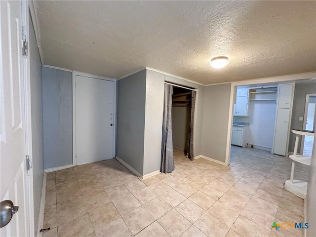 unfurnished bedroom with a textured ceiling