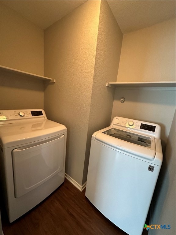 laundry area featuring dark hardwood / wood-style flooring and separate washer and dryer