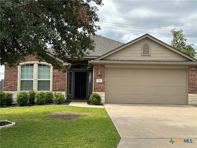 single story home featuring a front lawn and a garage