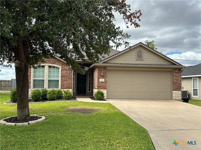 single story home with a garage and a front lawn