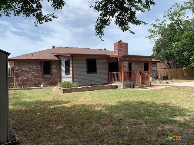 3002 Veterans Ave, Copperas Cove, TX 76522 - back of property featuring a chimney, brick siding, and a patio