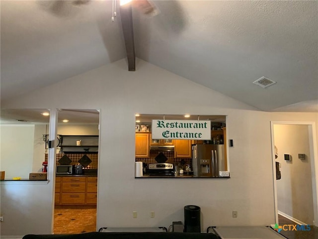 3002 Veterans Ave, Copperas Cove, TX 76522 - detailed view of stainless steel appliances, ceiling fan, under cabinet range hood, beamed ceiling, and tasteful backsplash