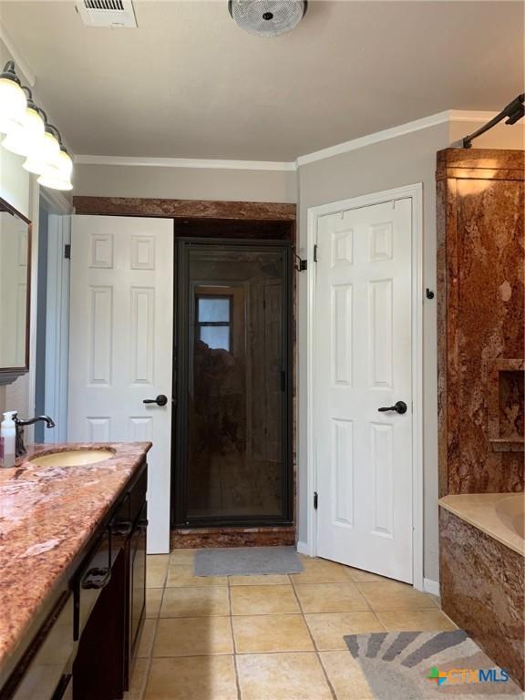 3002 Veterans Ave, Copperas Cove, TX 76522 - full bathroom featuring vanity, a shower, a bath, tile patterned floors, and crown molding