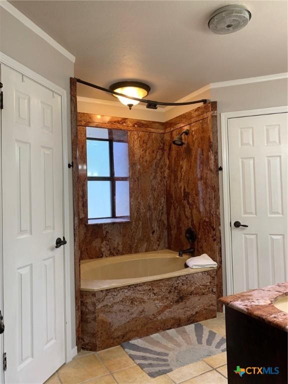 3002 Veterans Ave, Copperas Cove, TX 76522 - bathroom featuring crown molding, tile patterned floors, vanity, and a combined bath / shower with marble appearance