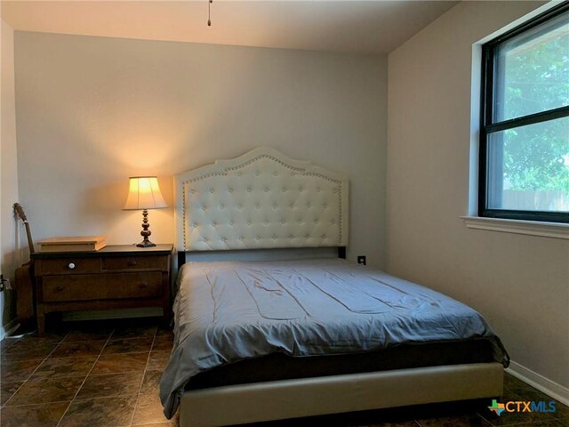 3002 Veterans Ave, Copperas Cove, TX 76522 - bedroom with baseboards and dark stone finish floors