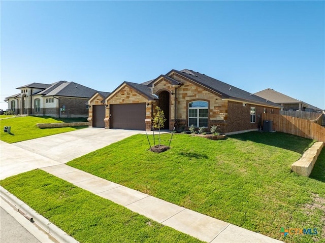 single story home with a front lawn, central AC unit, and a garage