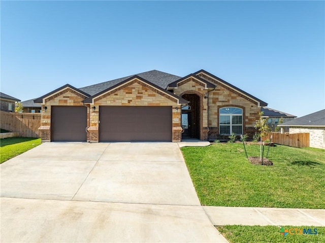 view of front of house with a garage and a front lawn